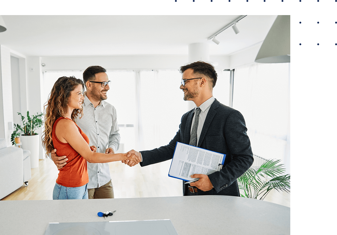 Couple shaking hands with real estate agent.